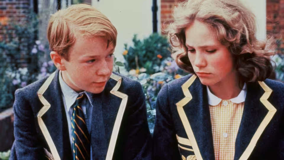 Alan Duckworth (John Albasiny) looks toward Ann Lawton (Abigail Cruttenden) in their school uniforms