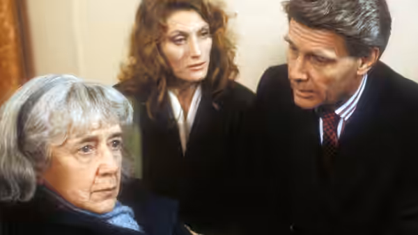 Lillian Huckle (Peggy Ashcroft) sits as Harriet Ambrose (Geraldine James) watches Hugh Ambrose (James Fox) lean toward her