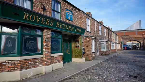 The Rovers Return Inn stands along a cobbled street of brick terraces