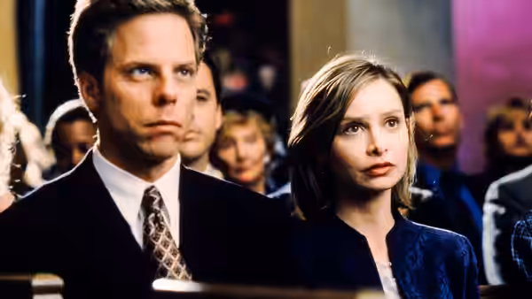 Billy Thomas (Gil Bellows) and Ally McBeal (Calista Flockhart) sit among a courtroom audience
