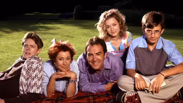 Ben Harper (Robert Lindsay), Susan Harper (Zoë Wanamaker) and family lie together on the grass