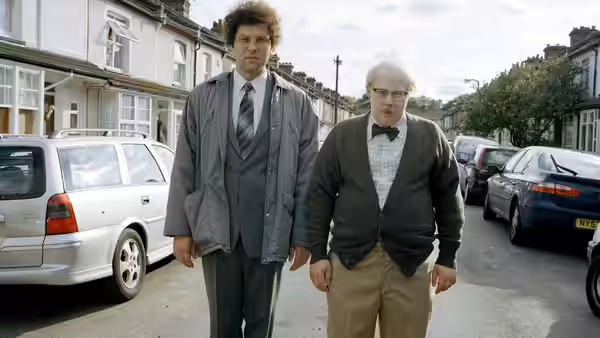 Lou (David Walliams) and Andy (Matt Lucas) walk along a residential street