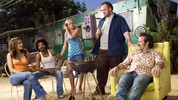 Catalina, Darnell, Joy, Randy, and Earl gather around a barbecue grill in the yard