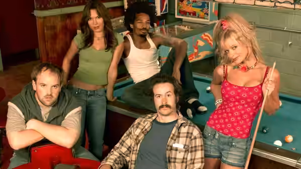 Earl and Randy pose beside Catalina, Darnell, and Joy around a pool table