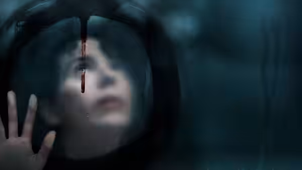 A woman gazes upward through a circular window with dripping blood