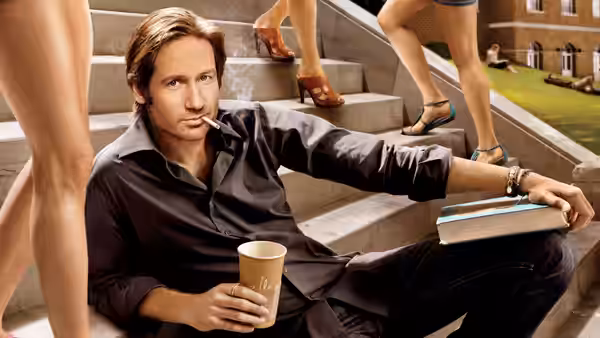Hank Moody (David Duchovny) sits on outdoor steps with a cigarette and coffee