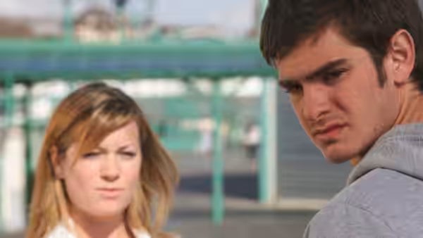Jack (Andrew Garfield) looks back beside a woman at an outdoor walkway