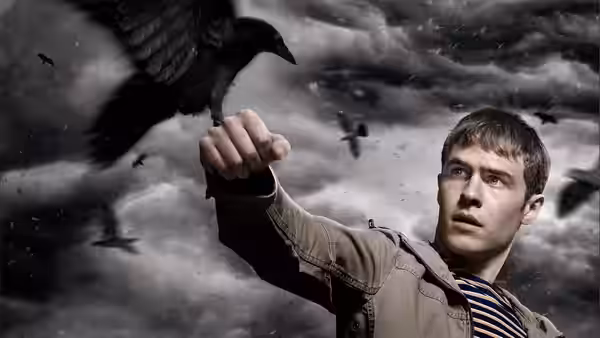 Paul Roberts (Iain De Caestecker) reaches toward a crow beneath a sky filled with birds
