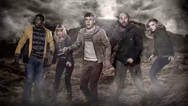 Paul Roberts (Iain De Caestecker) and Mac Armstrong (Daniel Kaluuya) stand with three companions in a stormy wasteland