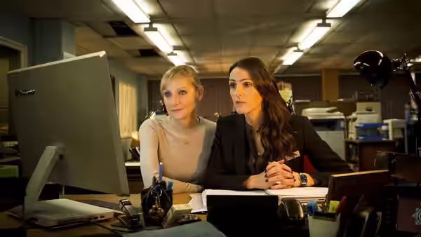 Janet Scott (Lesley Sharp) and Rachel Bailey (Suranne Jones) work together at a computer in the police office