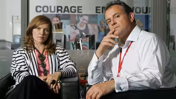 Sally Owen (Olivia Colman) and Ian Fletcher (Hugh Bonneville) sit together in the office