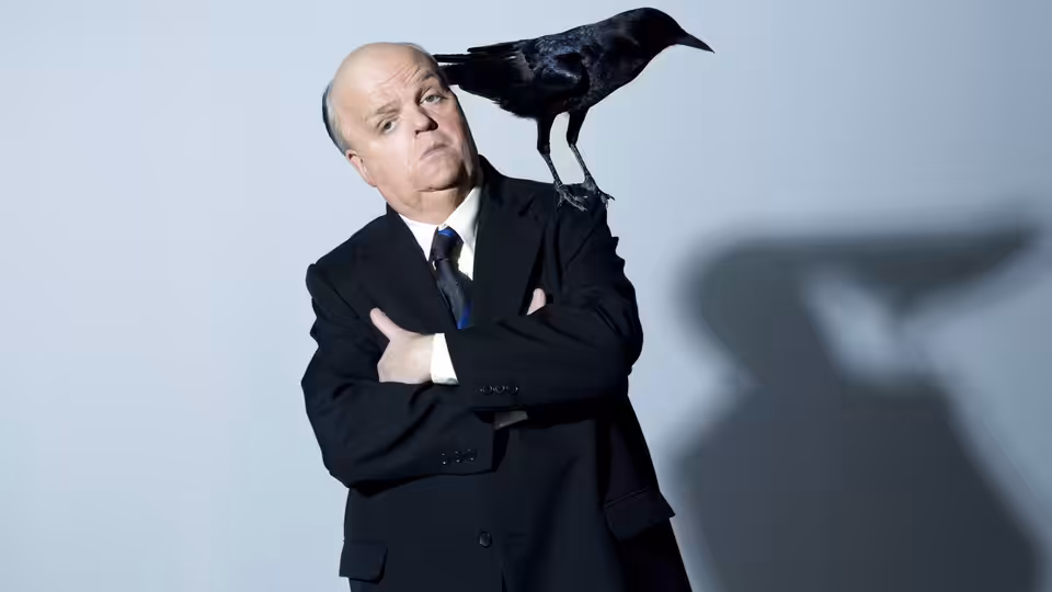 Alfred Hitchcock (Toby Jones) stands with a crow perched on his shoulder, arms crossed