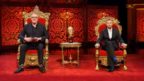 Greg Davies and Alex Horne sit on ornate red-and-gold thrones in a decorated room