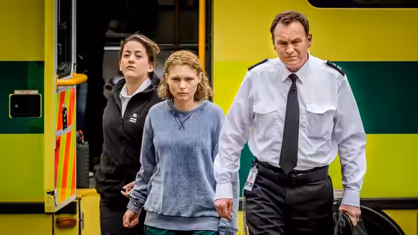David Murdoch (Philip Glenister) escorts Lucy Murdoch (Sammy Winward) beside an ambulance