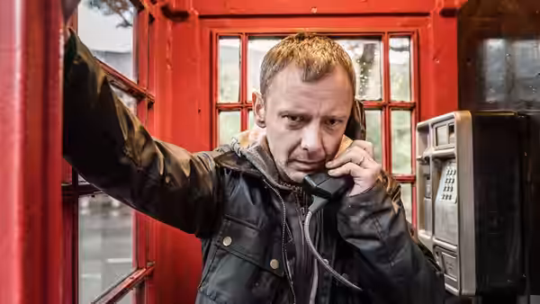 Marcus Farrow (John Simm) makes a phone call from a red telephone booth
