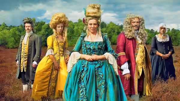 A group in elaborate eighteenth-century clothing stands together in an open field