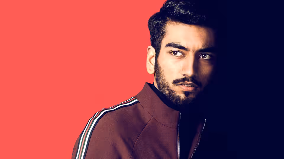 Raza Shar (Nabhaan Rizwan) looks to the side against a red background