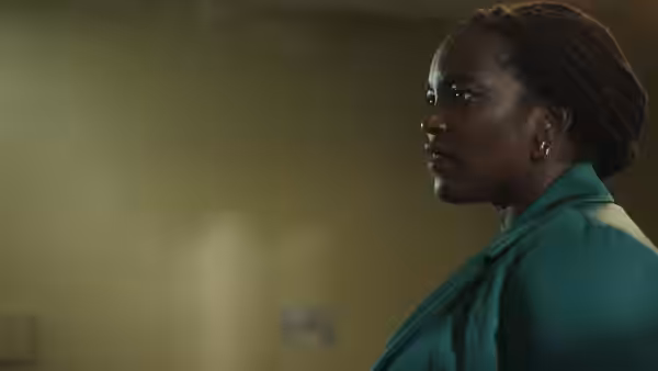 DI Mercer (Wunmi Mosaku) stands in profile inside a room