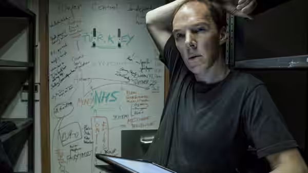 Dominic Cummings (Benedict Cumberbatch) studies a crowded planning whiteboard in an office