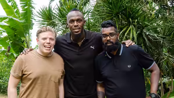 Rob Beckett and Romesh Ranganathan pose with Usain Bolt among tropical plants