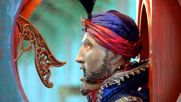 Zoltar fortune teller in profile with red eye and ornate turban