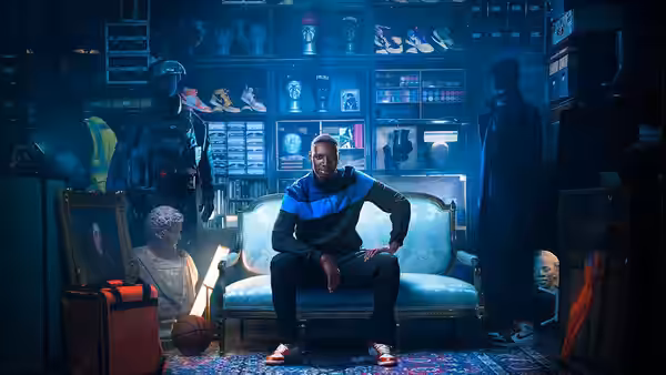 Assane Diop (Omar Sy) sits among curiosities and display cases in a crowded room