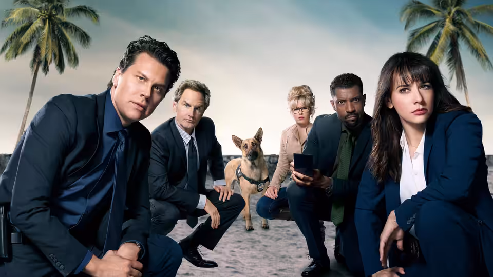 Angie Tribeca (Rashida Jones) crouches with fellow detectives and a dog on a beach