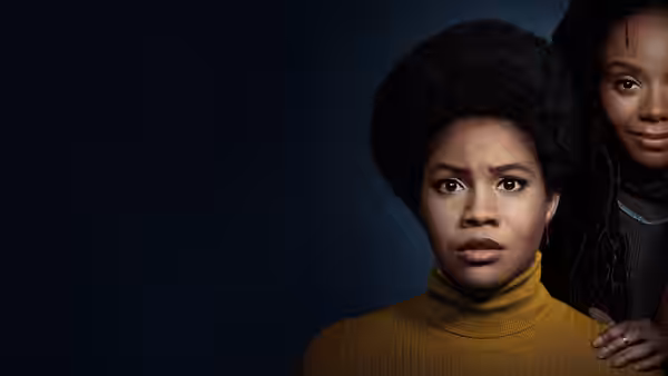 Nella (Sinclair Daniel) stands in front as Hazel (Ashleigh Murray) rests a hand on her shoulder