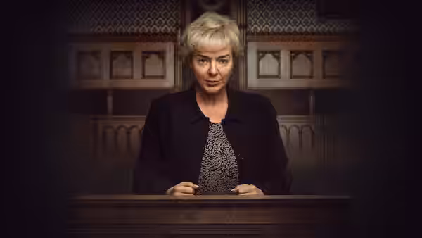 Ann Ming (Sheridan Smith) stands behind a wooden lectern in a courtroom