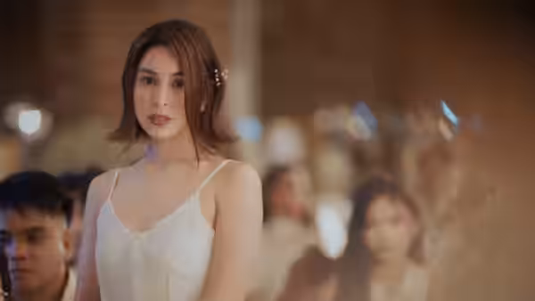 Luna (Julia Barretto) stands in a white dress among wedding guests
