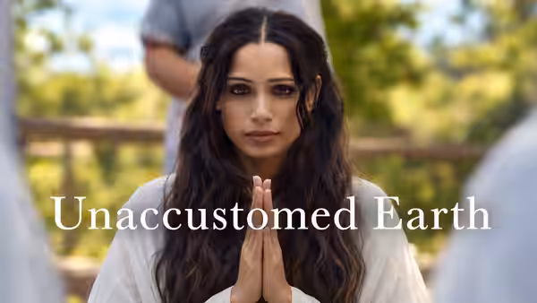 Parul Chaudhury (Freida Pinto) stands outdoors with her hands pressed together in prayer