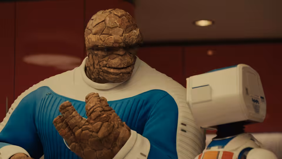 Ben Grimm (Ebon Moss-Bachrach) examining his rocky hand beside a robot