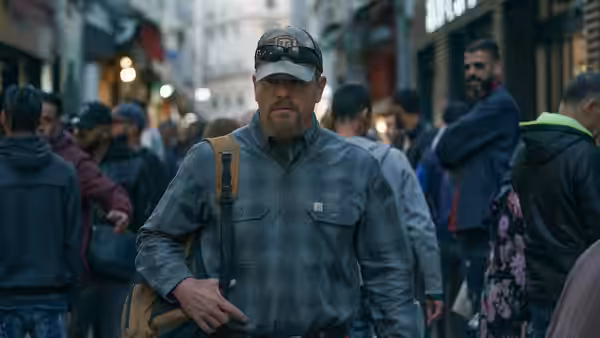 Bill Baker (Matt Damon) walks through a crowded market street