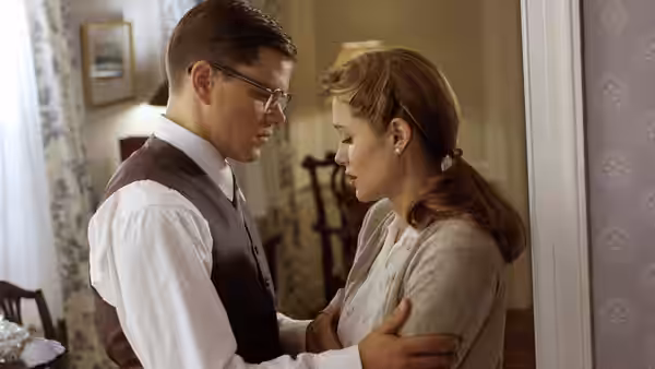 Edward Bell Wilson (Matt Damon) gently holds Margaret Ann Russell (Angelina Jolie) in a doorway