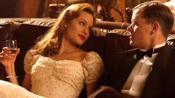 Margaret Ann Russell (Angelina Jolie) and Edward Bell Wilson (Matt Damon) sit together at a formal gathering