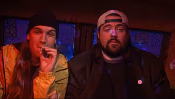 Jay and Silent Bob sit together in a dim, red-lit vehicle