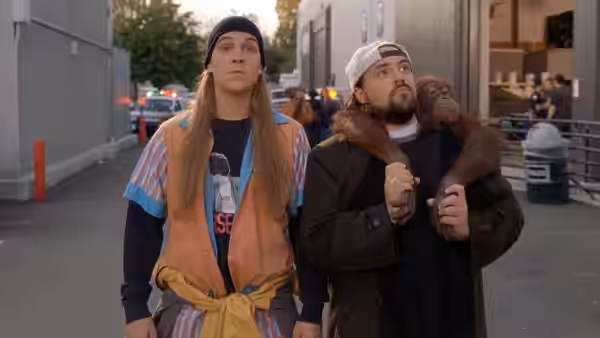 Jay (Jason Mewes) and Silent Bob (Kevin Smith) walk down a city street with a monkey