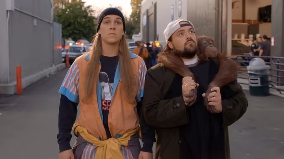 Jay (Jason Mewes) and Silent Bob (Kevin Smith) walk down a city street with a monkey