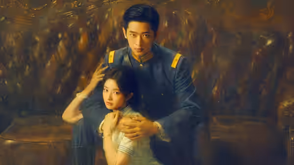 A uniformed man holds a woman seated in front of him