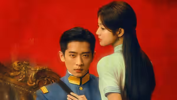 A uniformed man and a woman stand close against a red wall