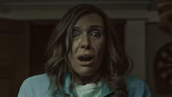 Annie (Toni Collette) staring ahead with wide eyes and open mouth