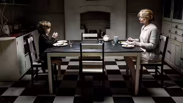 Amelia (Essie Davis) and Samuel (Noah Wiseman) eating dinner at the kitchen table