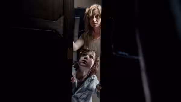 Amelia (Essie Davis) and Samuel (Noah Wiseman) peering through a doorway