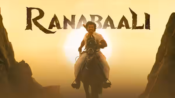 A mounted man rides through a narrow rocky pass against the setting sun