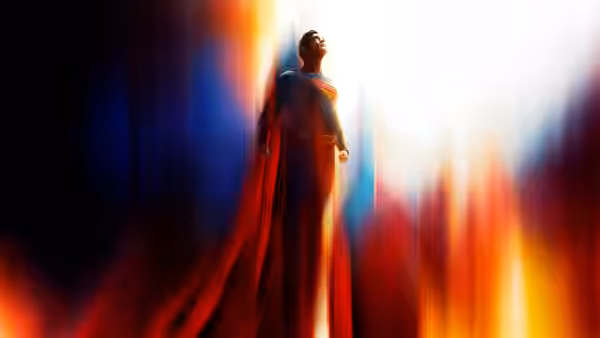 Superman stands with head tilted upward amid streaks of red and blue light