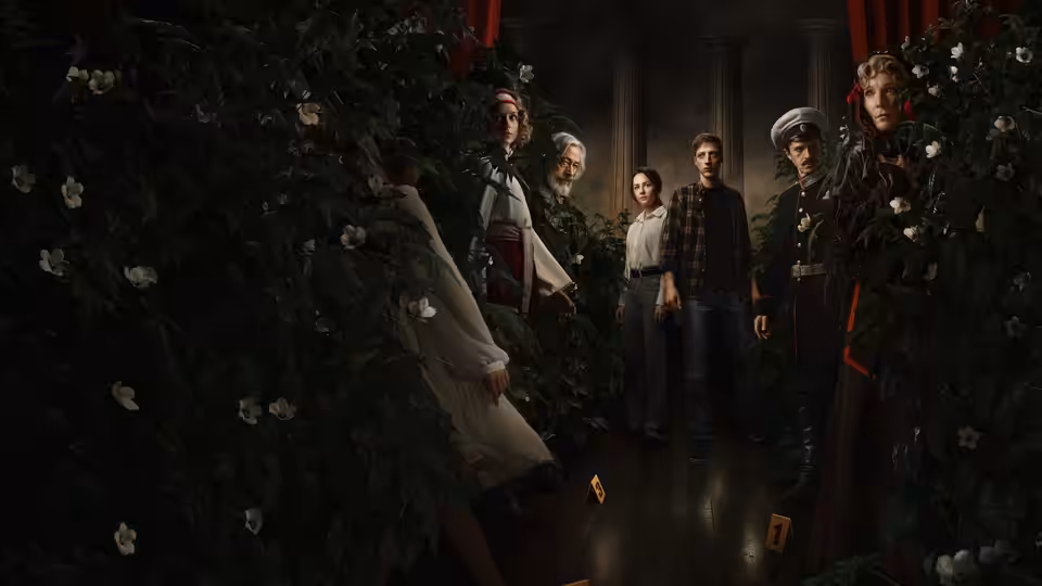 A group of people gathers in a dim corridor lined with dense greenery