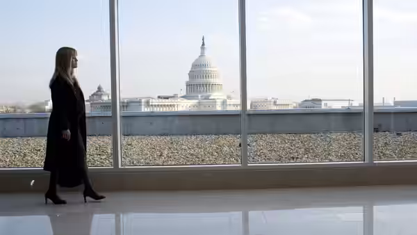 Isabella Fields El-Ibrahimi (Reese Witherspoon) stands before windows overlooking the Capitol