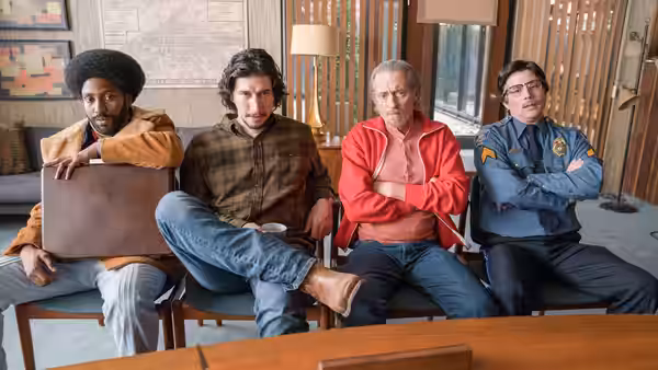 Ron Stallworth, Flip Zimmerman and two men sit in a lounge