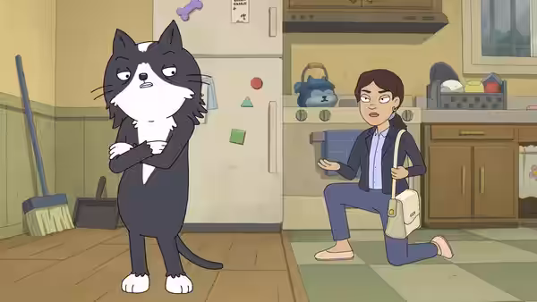 Kevin (Jason Schwartzman) stands with folded arms as a woman kneels beside him in a kitchen