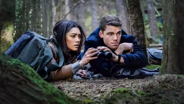 Rose Larkin (Luciane Buchanan) and Peter Sutherland (Gabriel Basso) lie concealed in the forest